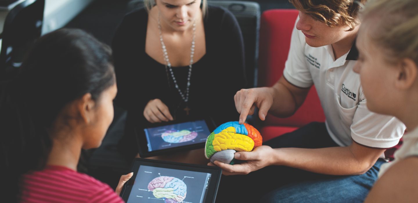 Campus group looking at brain model