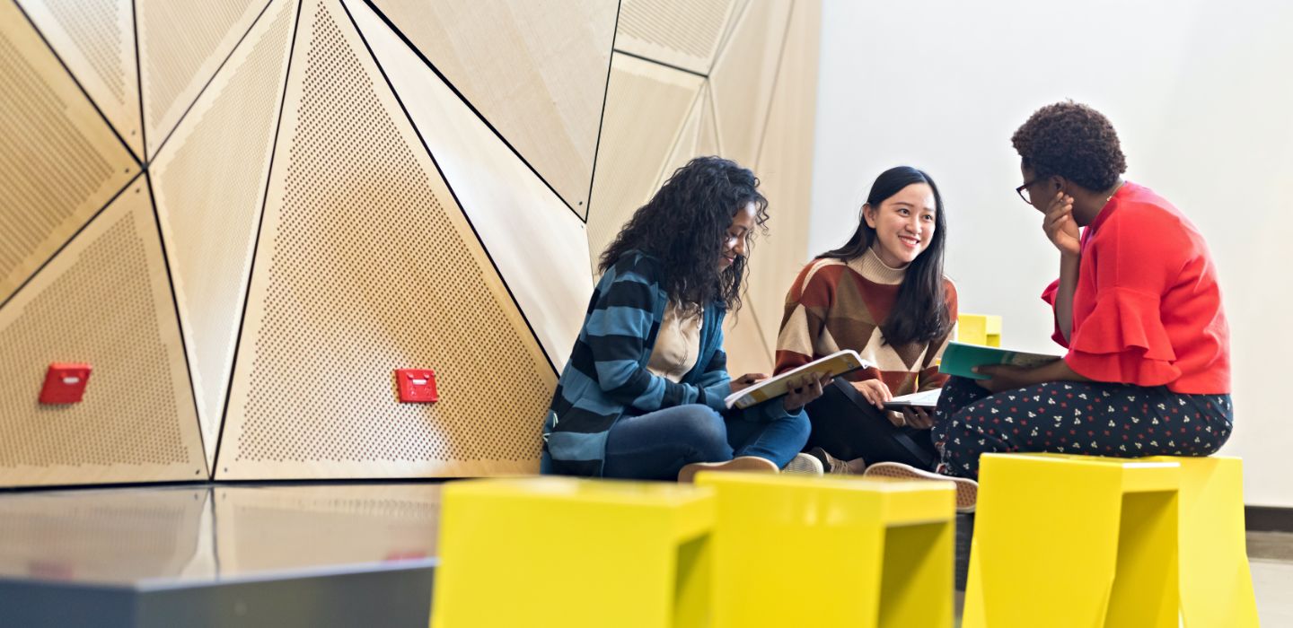Campus group of females reading books