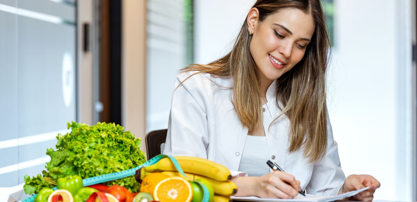 Off campus female nutritionist writing in book